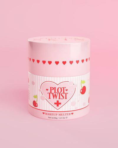 Vaaleanpunainen säiliö P.Louise Plot Twist Makeup Melting Cleansing Balm -puhdistusvoidetta, jonka etiketissä on sydän- ja kirsikkakuvioita vaaleanpunaista taustaa vasten