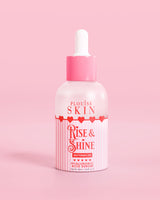 Vaaleanpunainen punainen ja valkoinen pullo P.Louise Rise & Shine Hyaluronic Acid -seerumia vesimelonissa