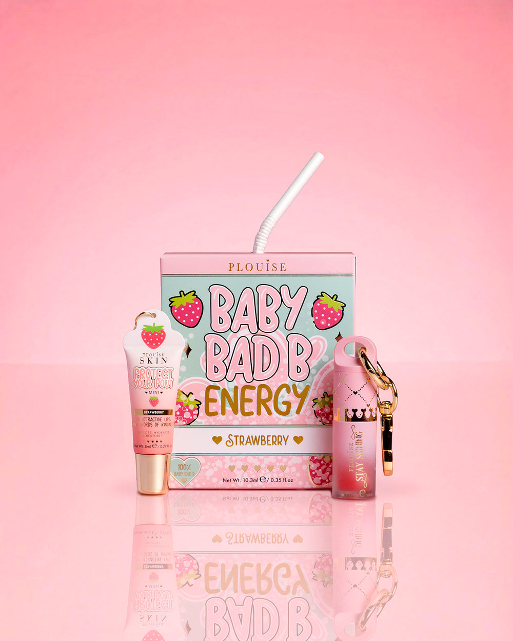 P.Louise Strawberry Baby Bad B Mini Lip Oil & Mini Lip Conditioner vaaleanpunaisella taustalla