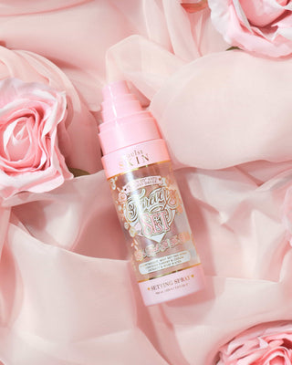 P. Louise Forever Set Bridal Setting Spray laid on a light pink fabric background surrounded by light pink roses