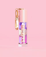 P. Louise Soak Me Lip Oil with colourful layered oil in a pink tube with a gold clasp on a pink background