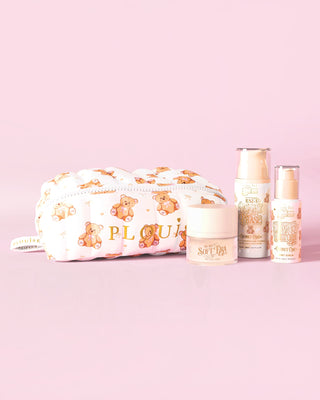 An image of The P.Louise Softest Touch Skincare Starter Kit with a large print teddy bear skincare and makeup bag and 3 skincare products against a pink background